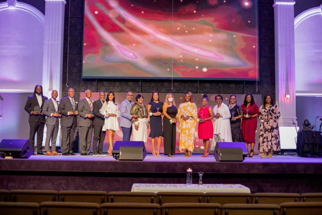 Honorees gathered on stage at an AAWHMP ceremony